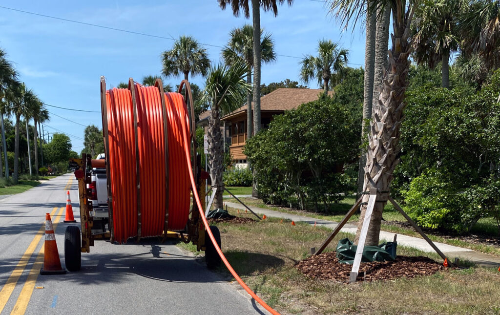 truck with roll of conduit for fiber-optic internet service.