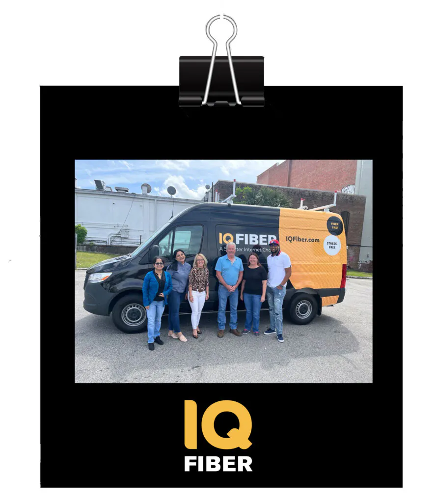Polariod-style photo of several IQ Fiber employees standing in front of an IQ Fiber truck.